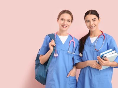 female medical students carrying books, bag and stethoscopes
