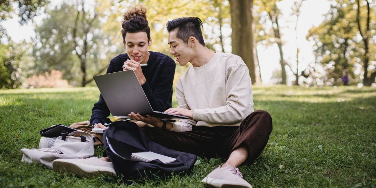 two college students looking for website to find scholarships