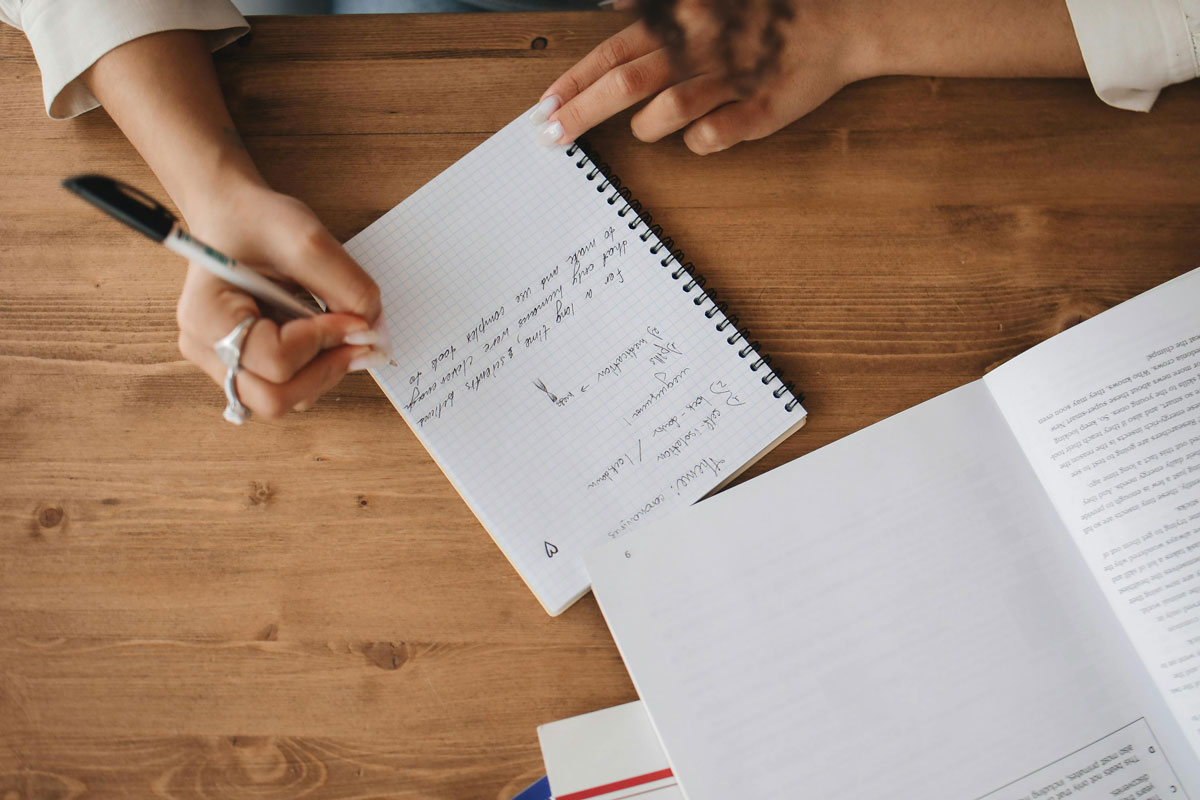 a person writing in a notebook