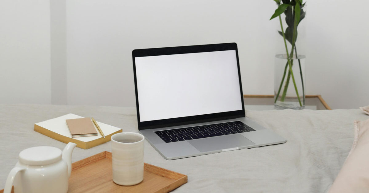 a laptop on a bed
