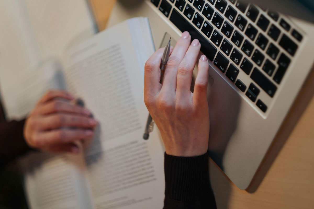 a person's hand on a laptop keyboard