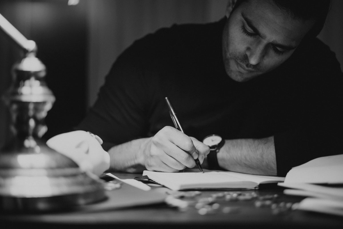 a man writing on a book