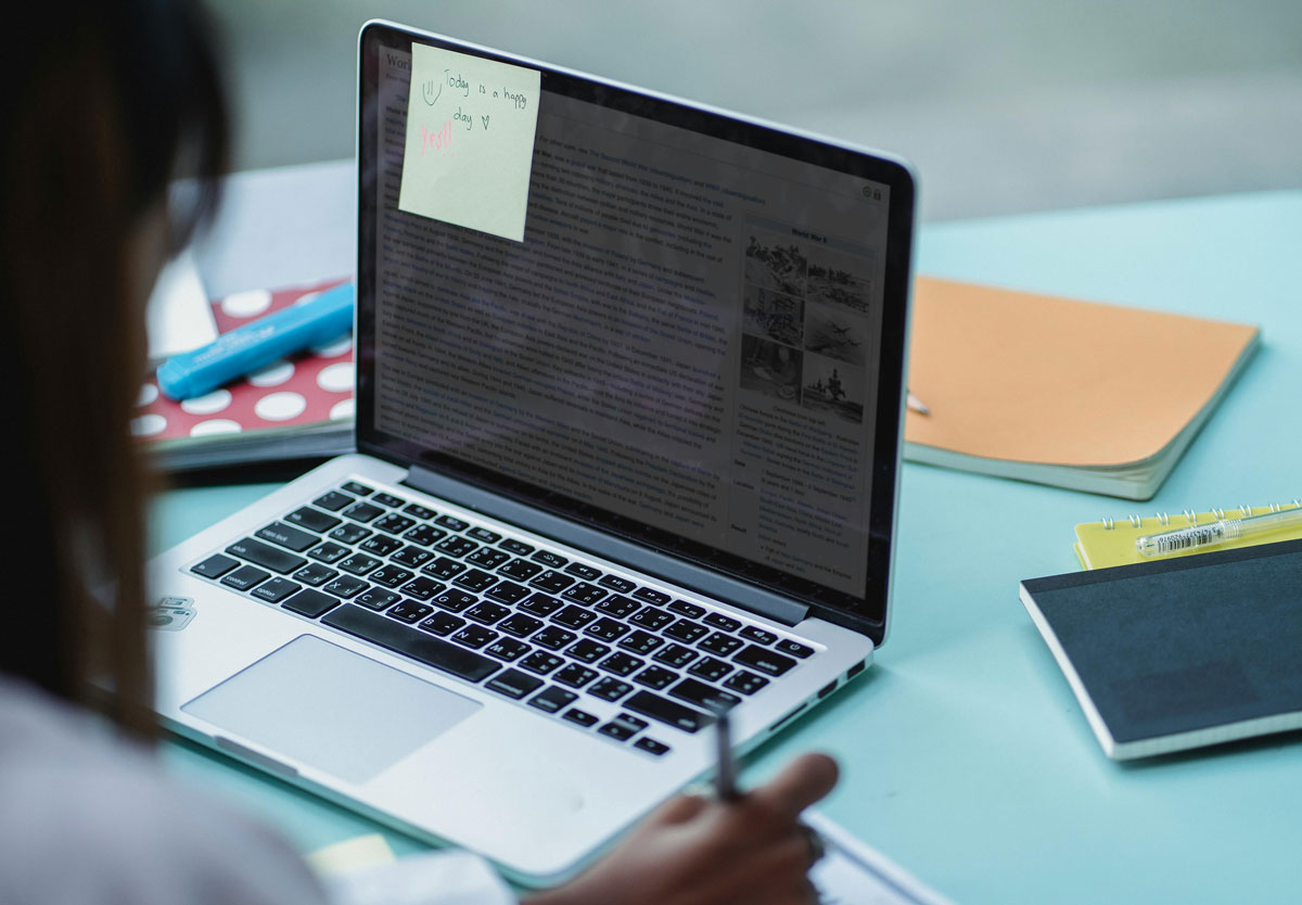 a person writing on a laptop