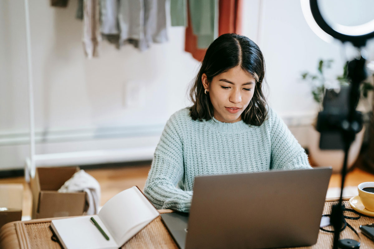 a woman sitting at a desk using a laptop