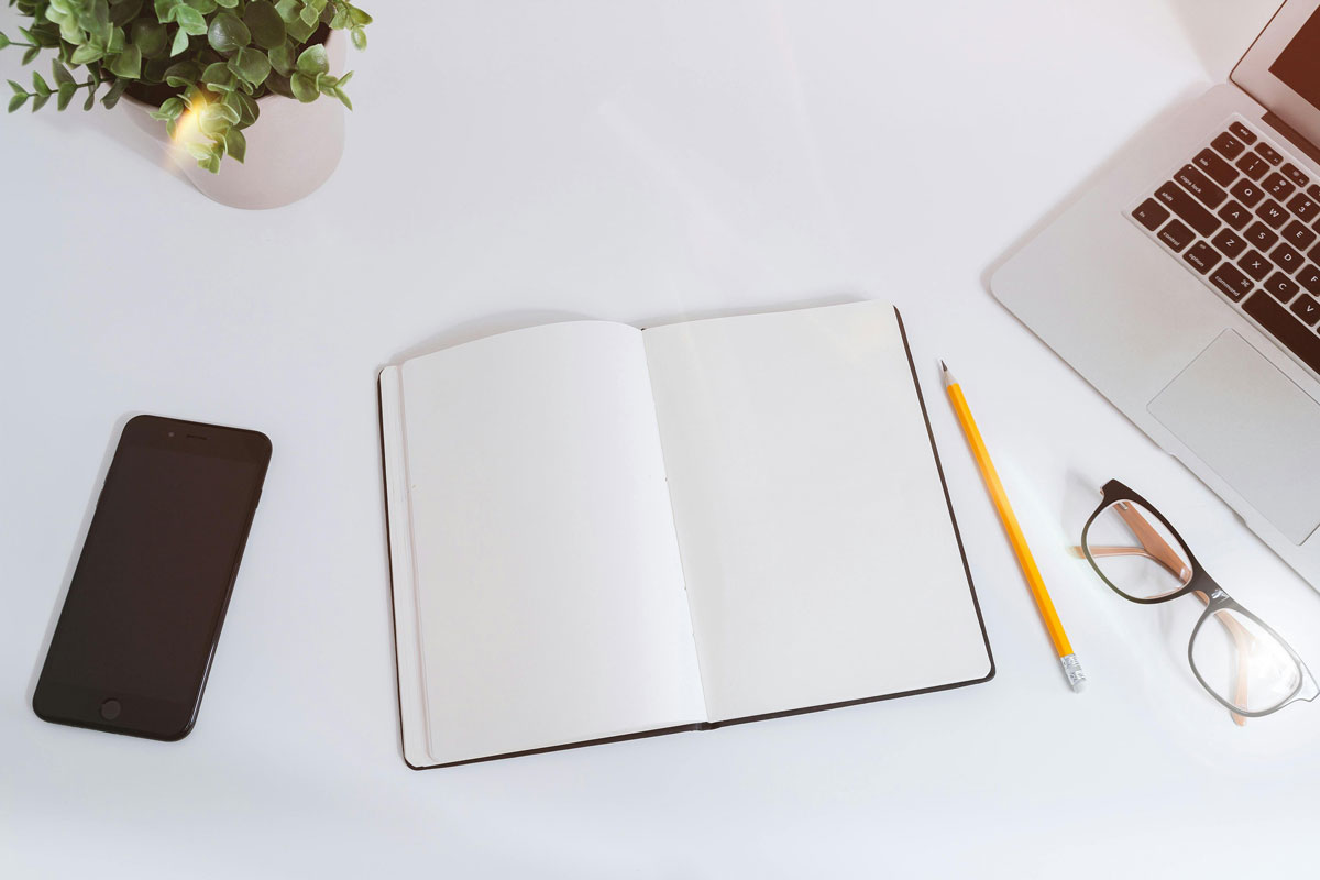 a notebook and pencil on a table