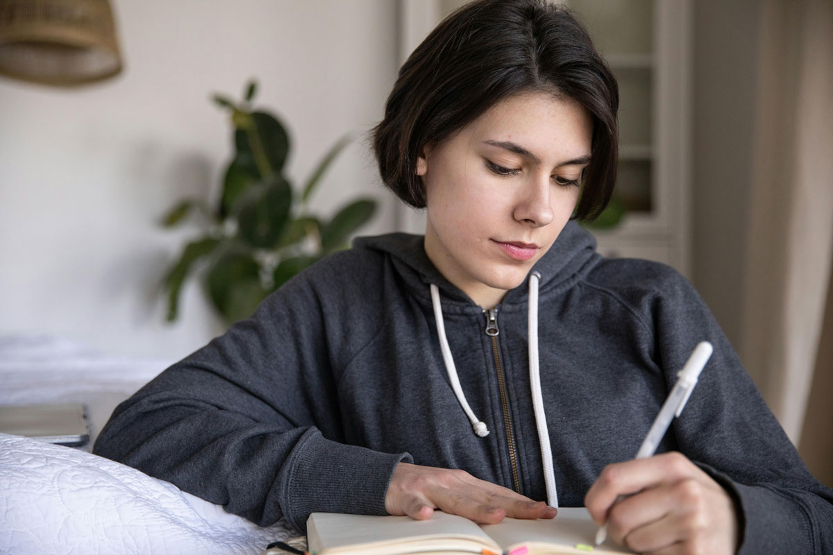 a woman writing in a book