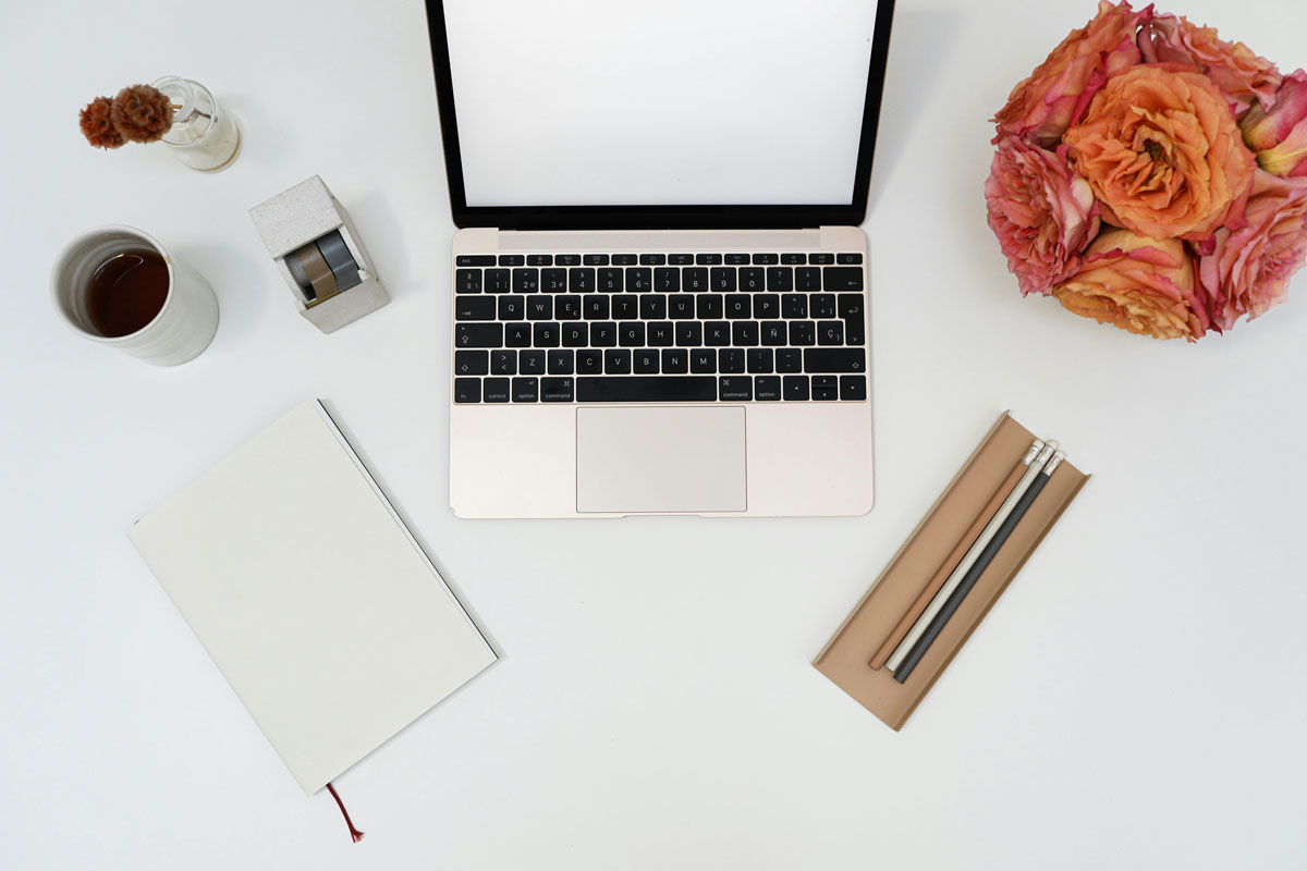 a laptop and a bouquet of roses