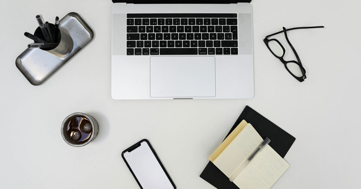 a laptop and other objects on a white surface