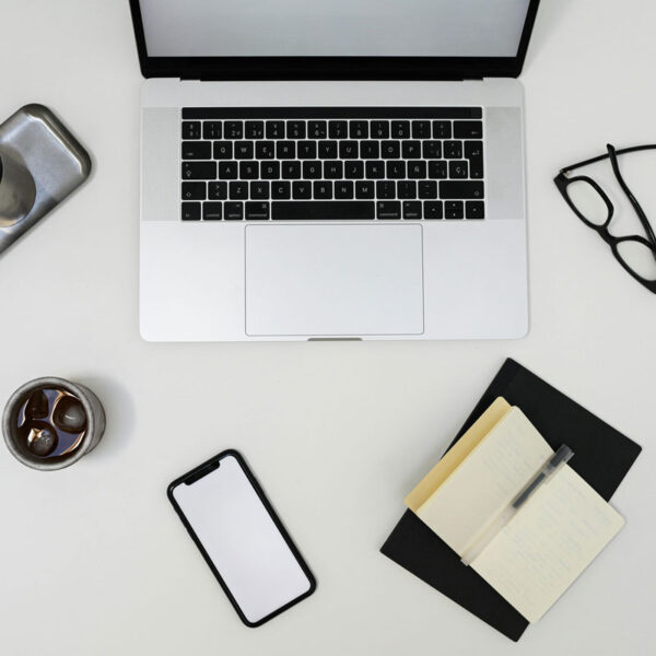 a laptop and other objects on a white surface