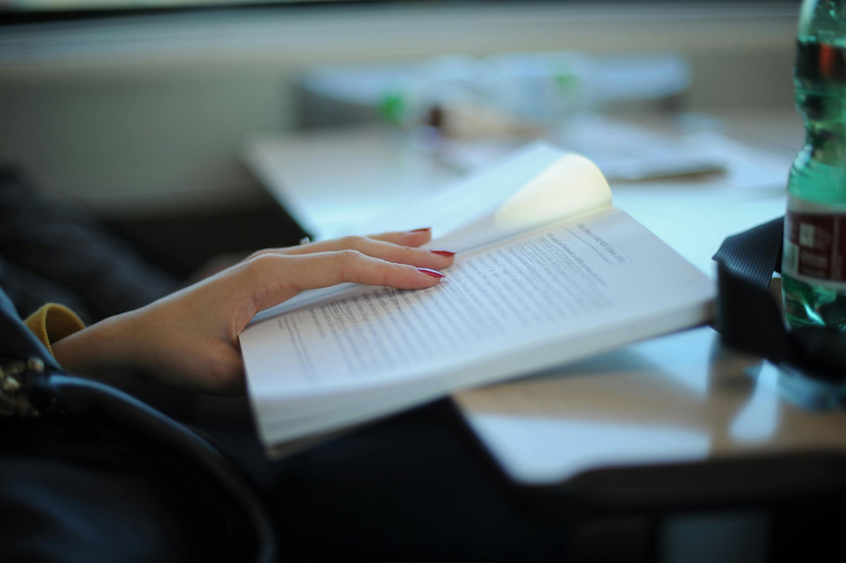 a hand holding a book