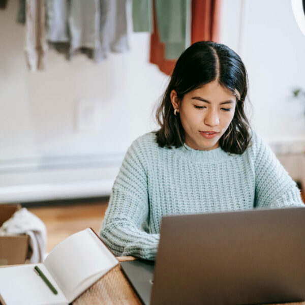 a woman sitting at a desk using a laptop