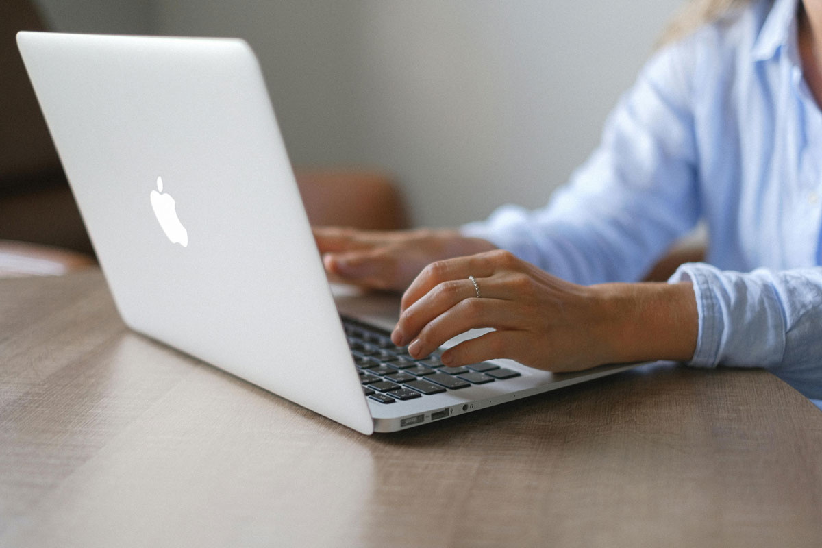 a person typing on a laptop