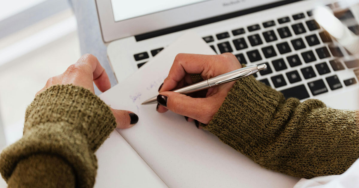 a person writing in a notebook