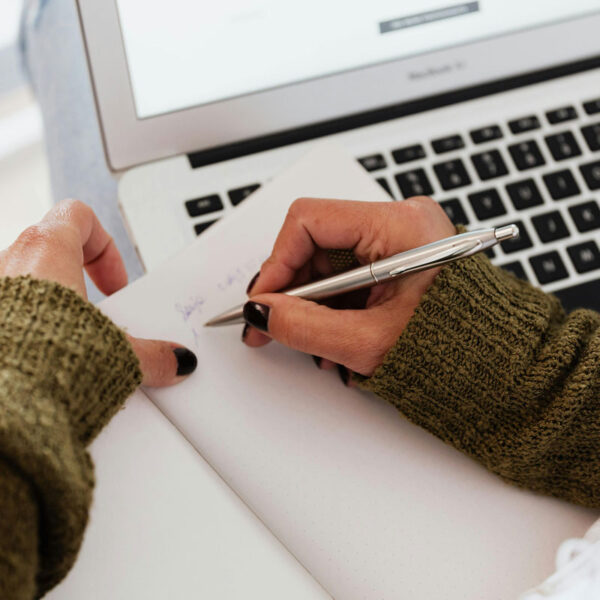 a person writing in a notebook
