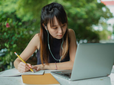 a woman writing on a notebook