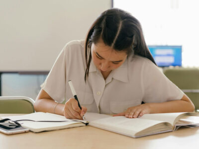 a woman writing in a book